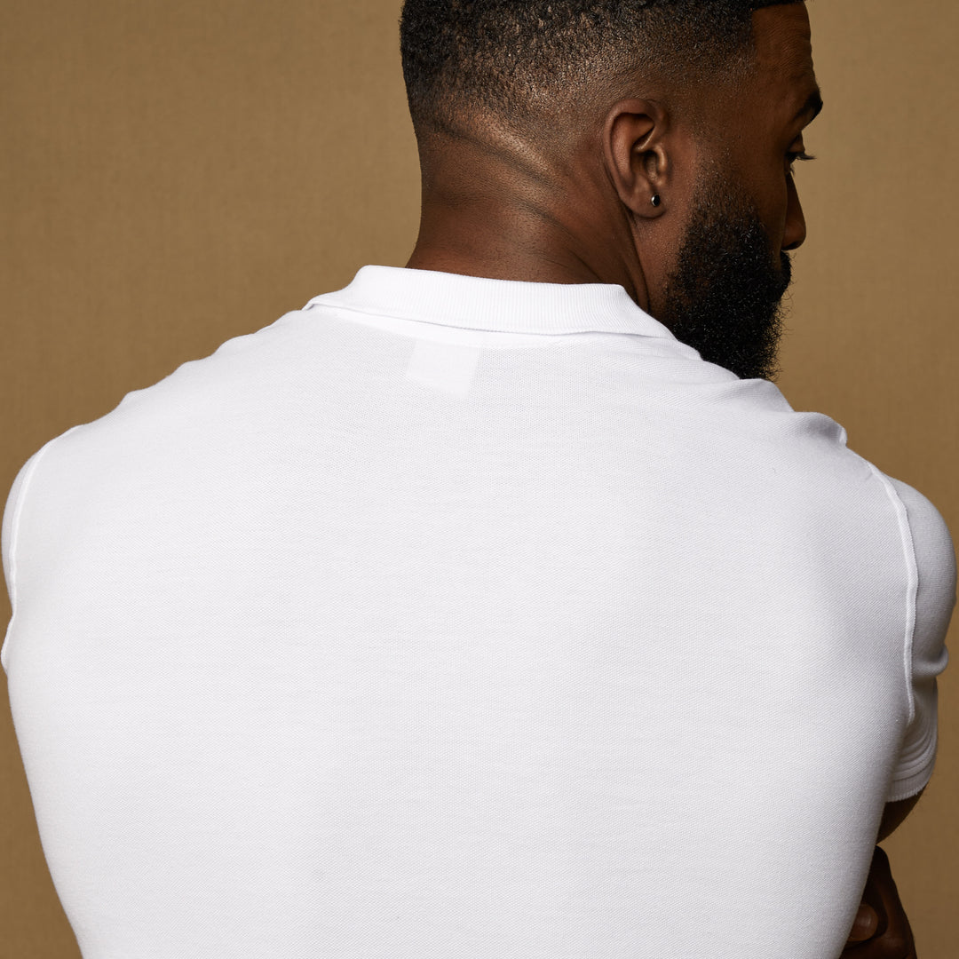 white tapered fit polo that has stretch fabric.