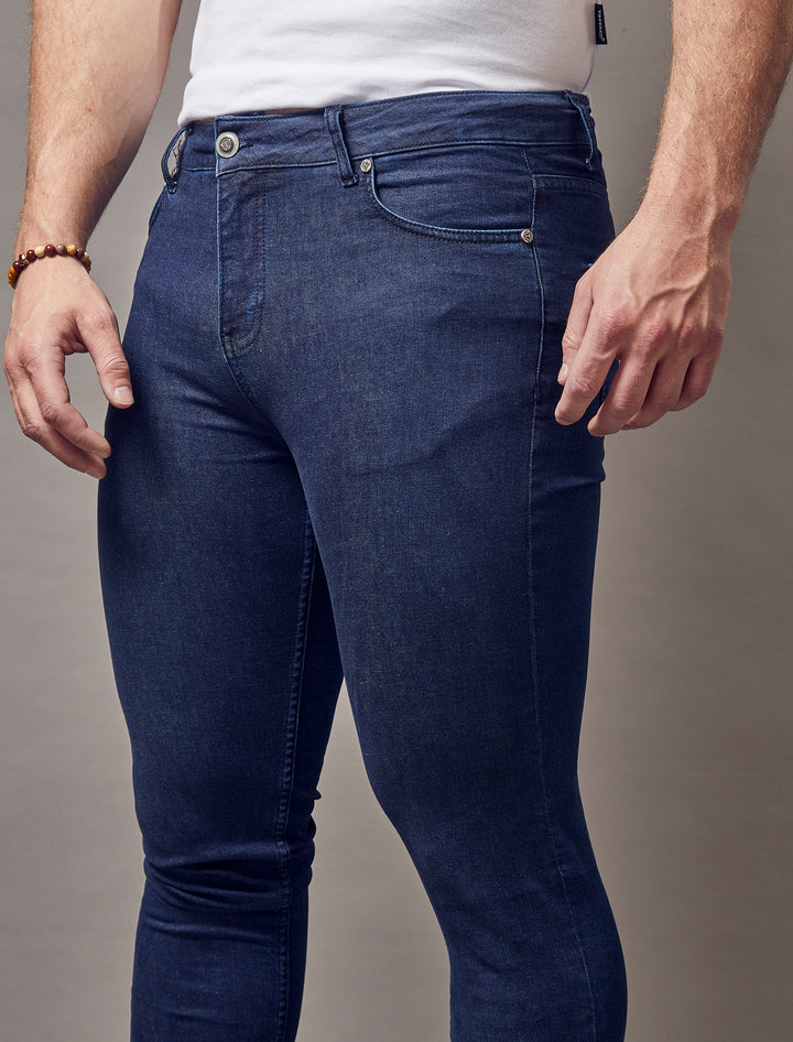 Tapered Menswear's navy muscle fit jeans, emphasizing their tapered silhouette and premium quality craftsmanship.