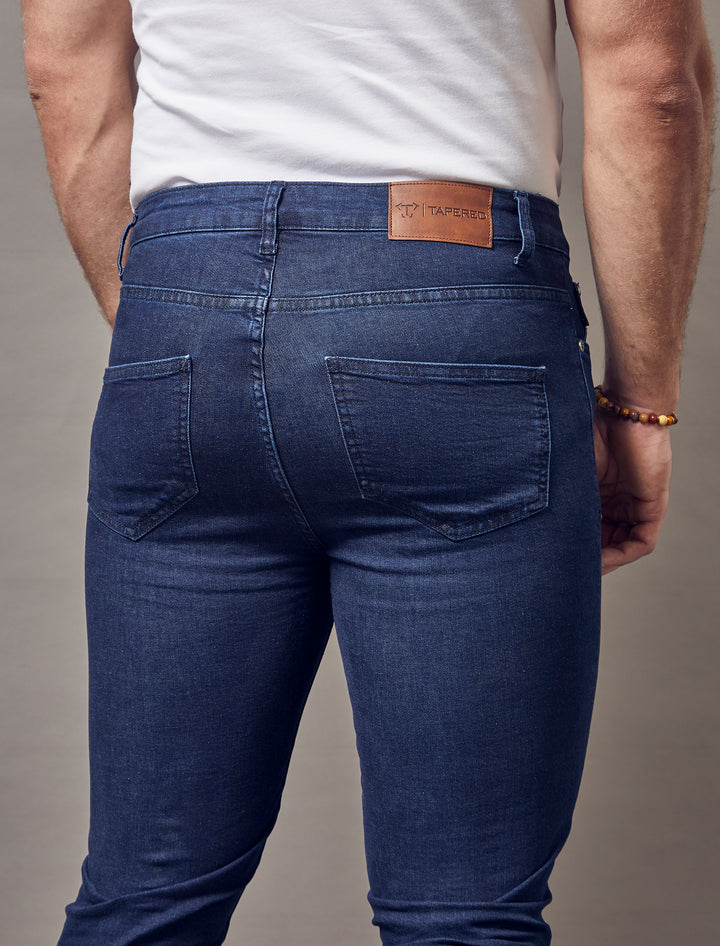 Navy jeans with a muscle fit, showcasing the tapered design and exceptional quality by Tapered Menswear.