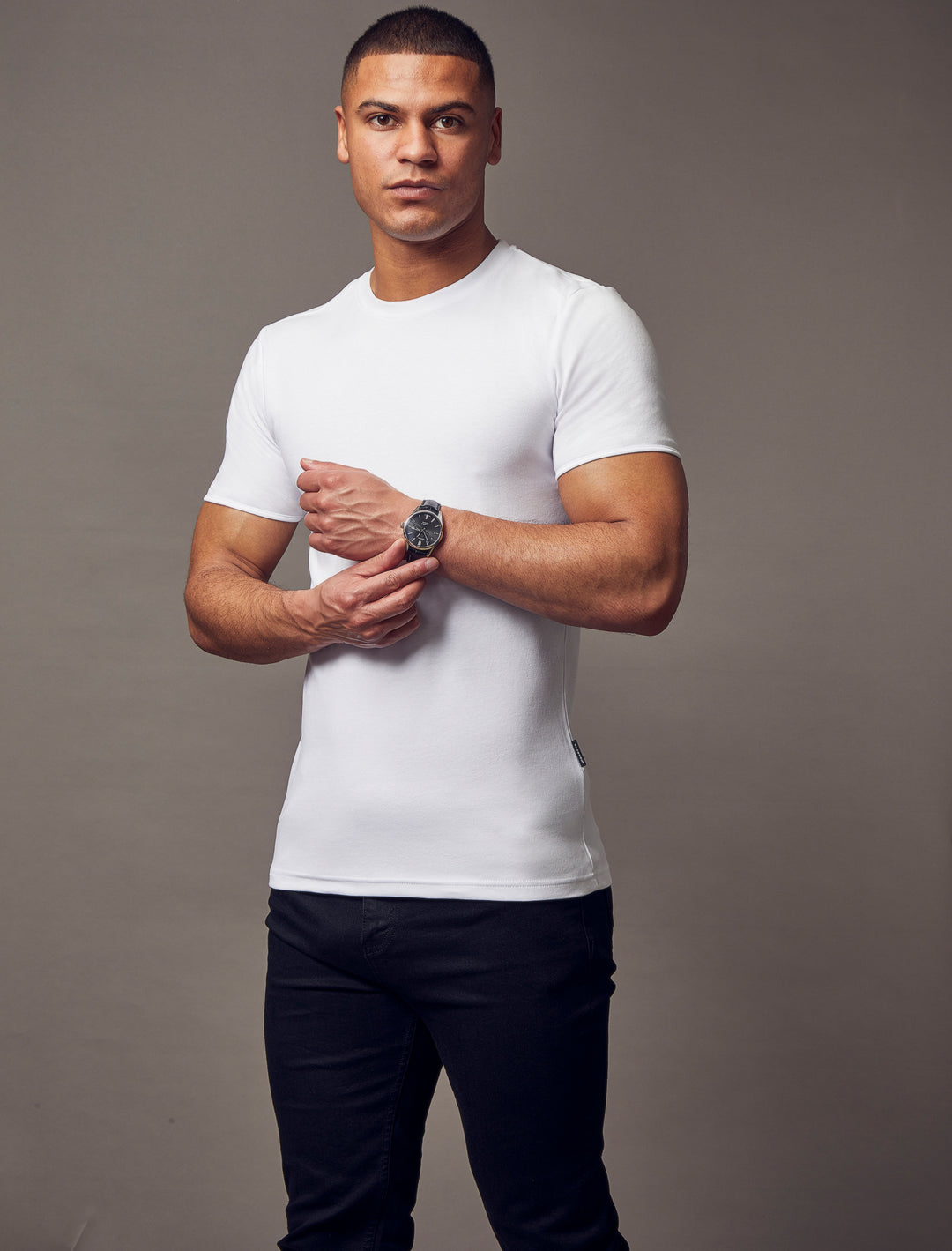 A white T-shirt with a tapered fit from Tapered Menswear, highlighting its muscle-fit design for a comfortable yet fashionable silhouette.