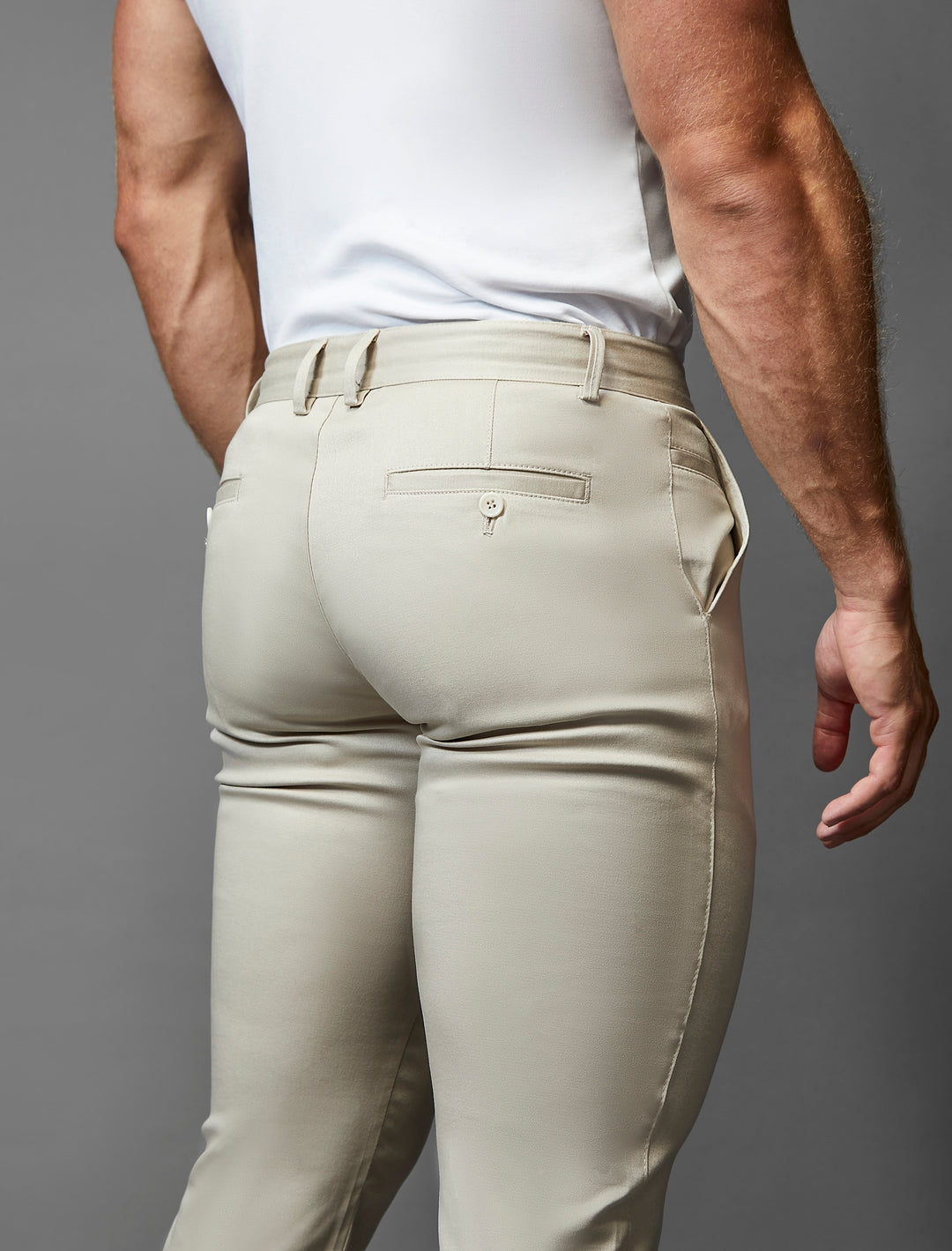 Experience the elegance of Tapered Menswear's stretch beige athletic fit chinos.