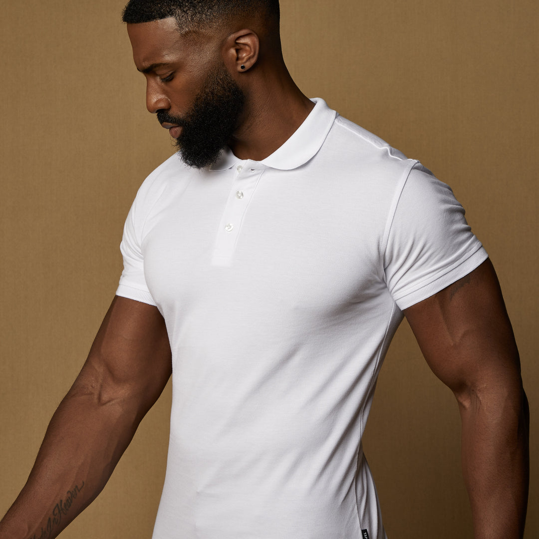 white tapered fit polo showing our signature v shaped cut