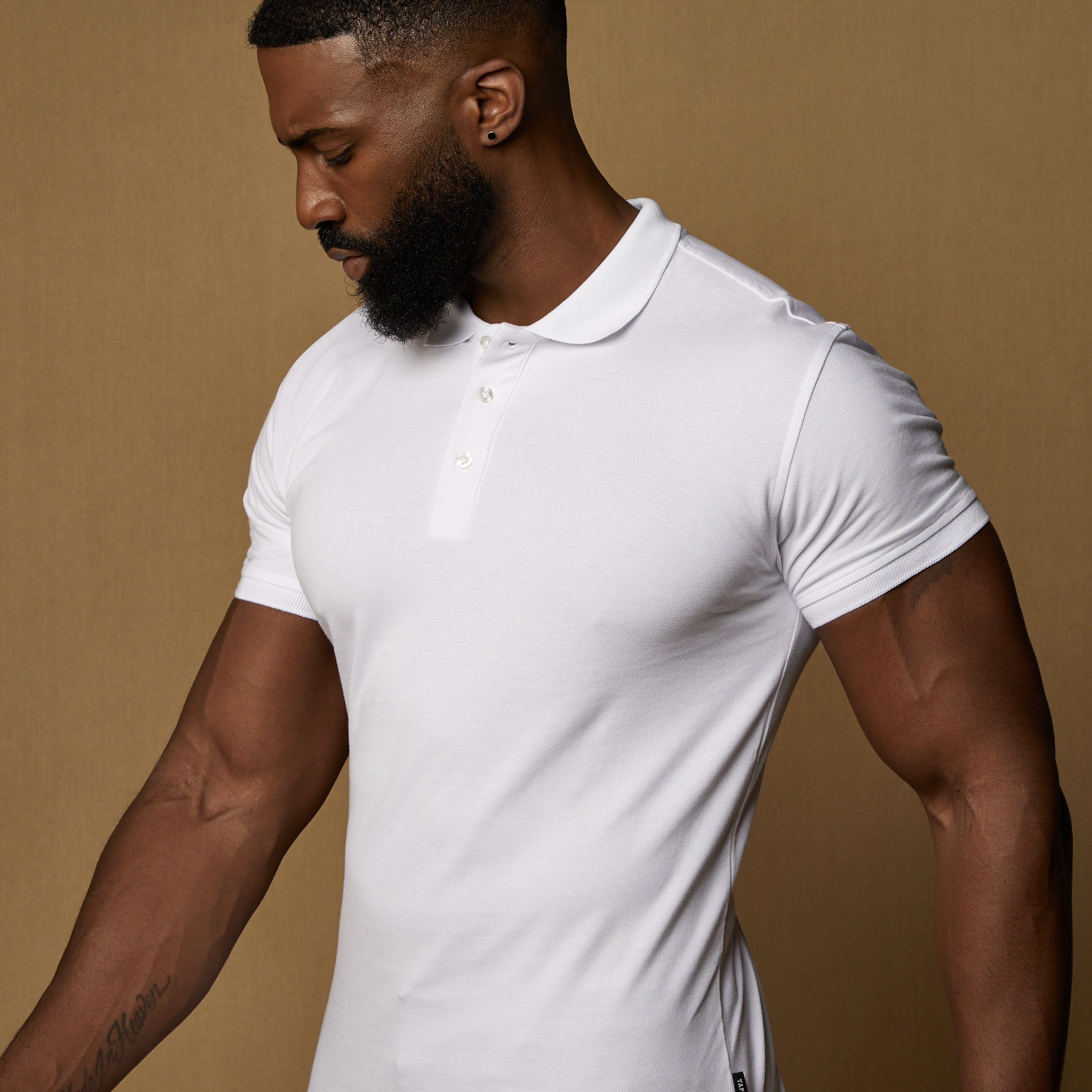 white tapered fit polo showing our signature v shaped cut