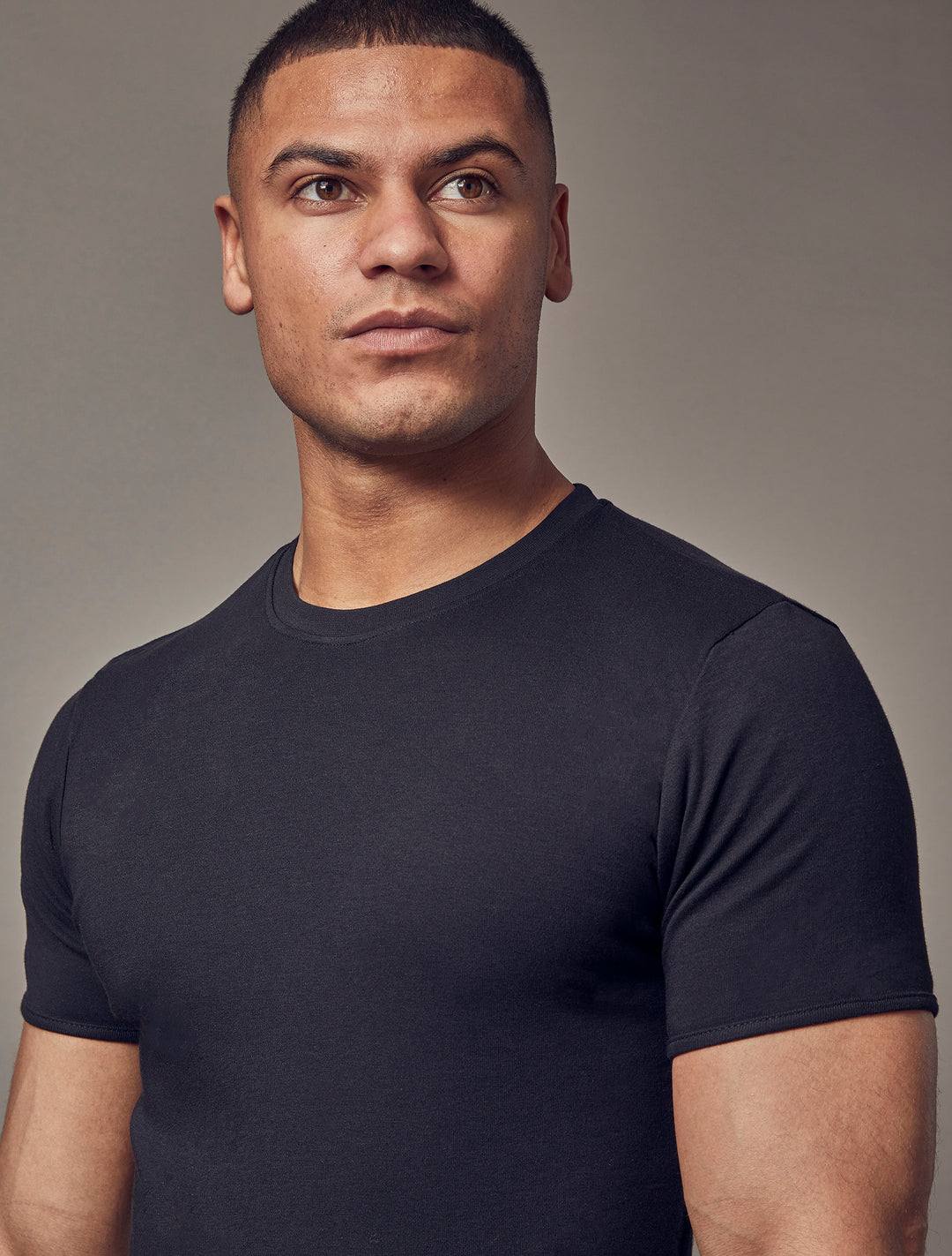 A black t-shirt with a tapered fit from Tapered Menswear, designed to accentuate the muscle fit features for a flattering and form-hugging appearance.