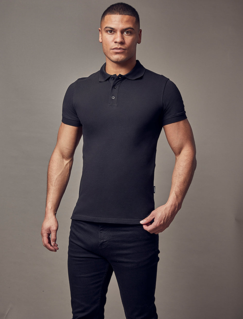 black muscle fit short sleeve polo shirt, highlighting the tapered fit and premium quality offered by Tapered Menswear