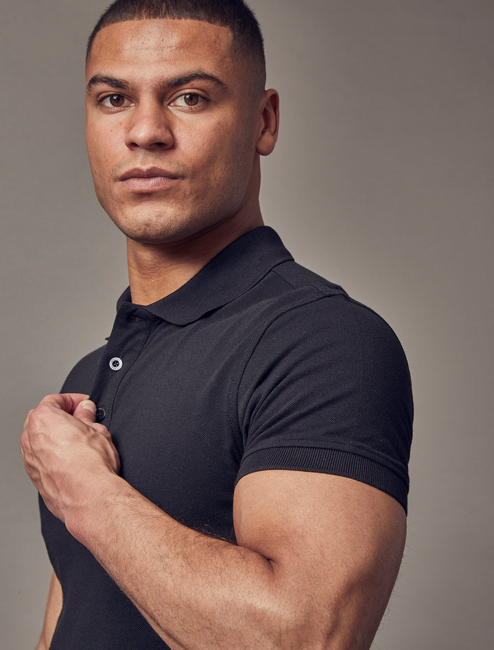 Black muscle-fit short sleeve polo shirt from Tapered Menswear, emphasizing its tapered fit and high-quality craftsmanship.