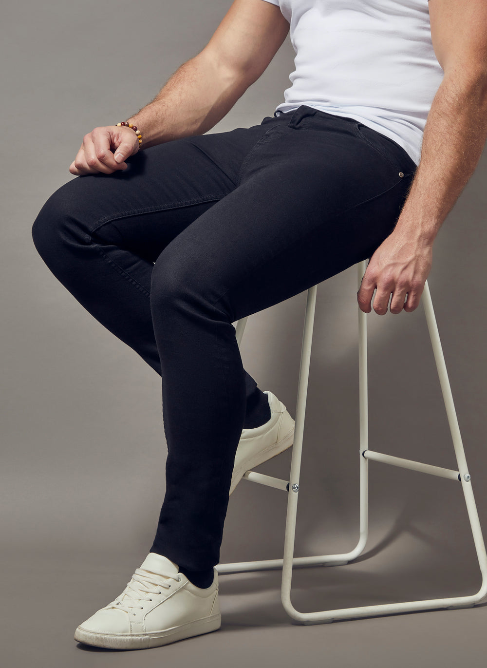 black tapered fit jeans, showcasing the muscle fit and superior quality offered by Tapered Menswear for the discerning man