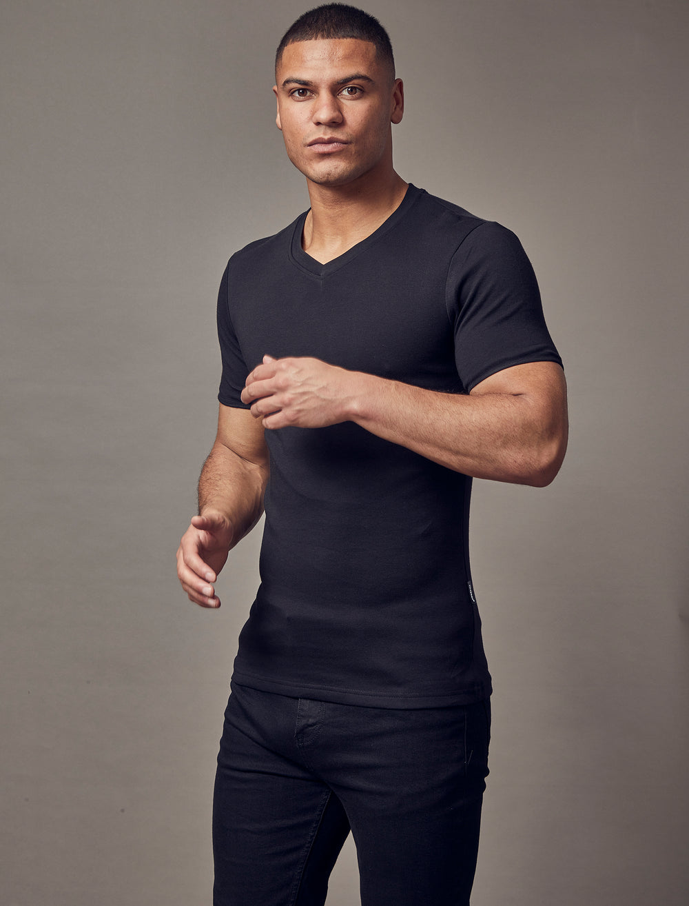 A black V-neck t-shirt from Tapered Menswear, featuring a tapered fit that emphasizes the muscle-fit design, creating an appealing and comfortable silhouette.