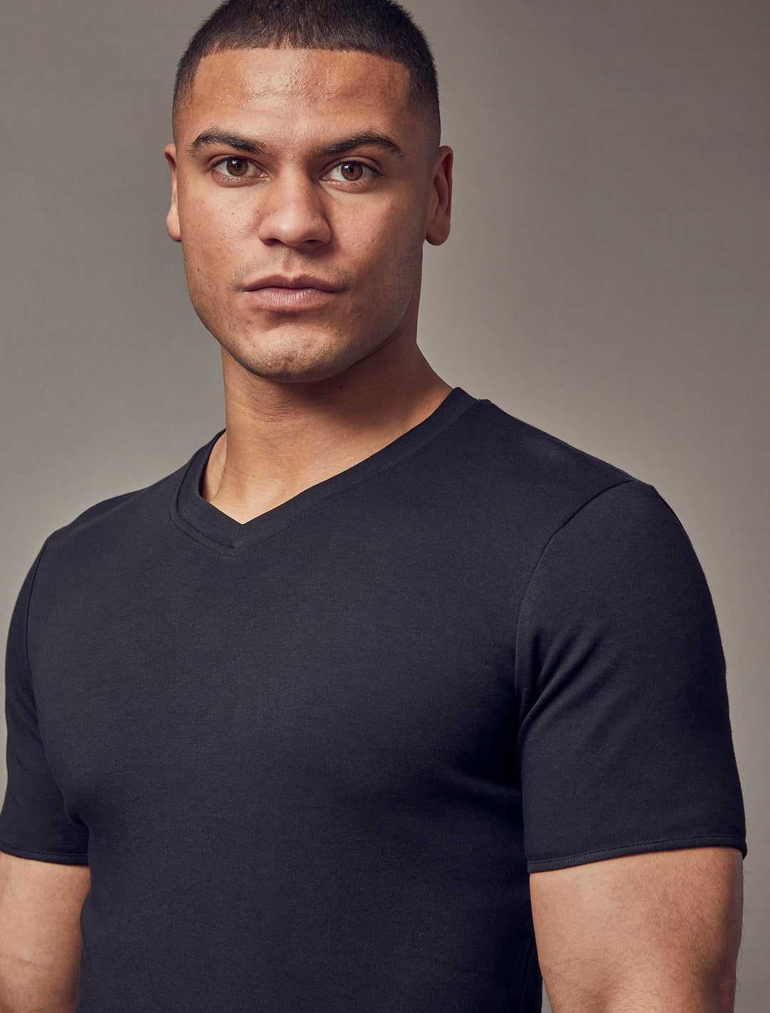Tapered Menswear's black V-neck t-shirt, crafted with a tapered fit that accentuates the muscle-fit style, offering an attractive and snug silhouette.