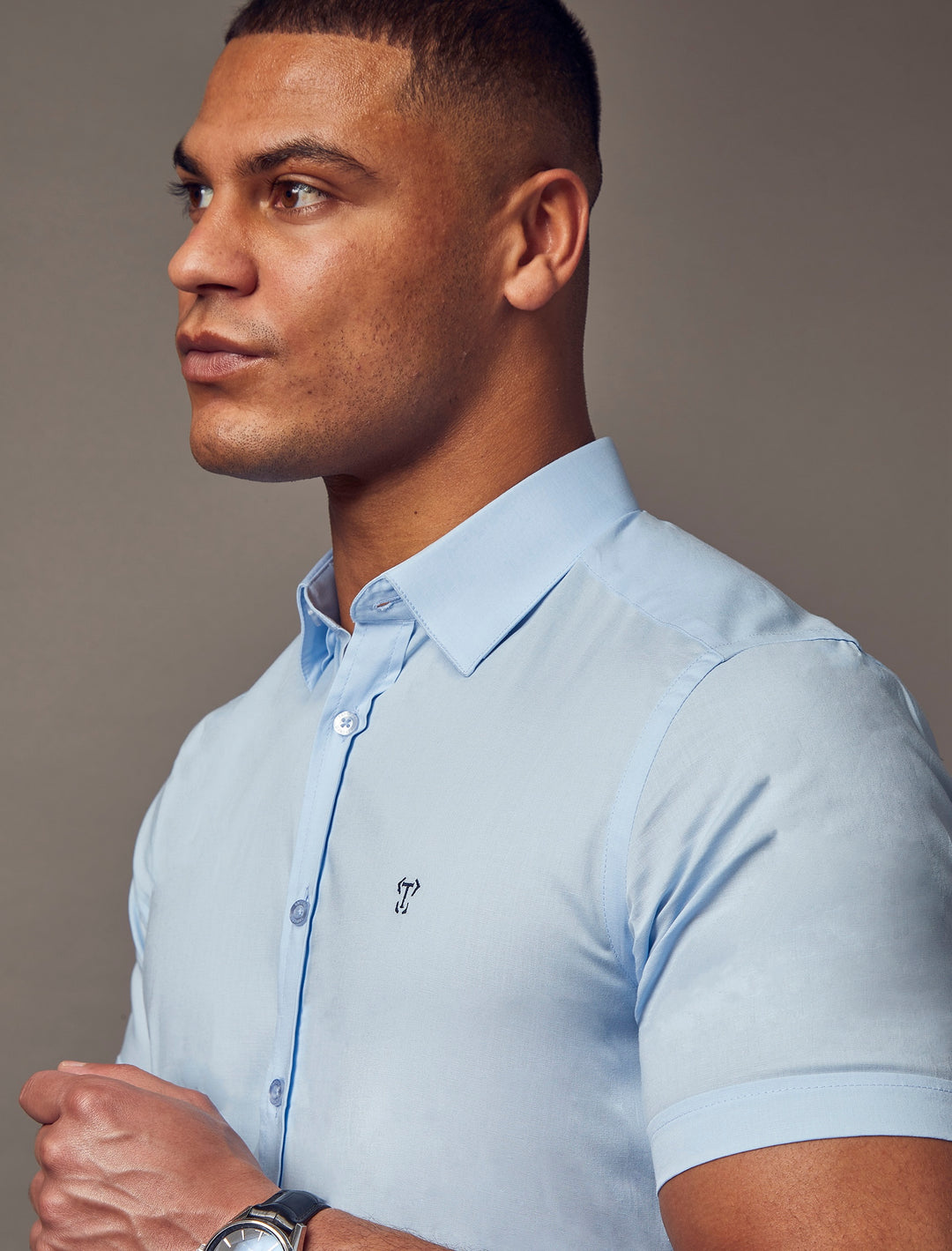 blue muscle fit short sleeve shirt close up shot, highlighting the tapered fit and superior quality offered by Tapered Menswear for athletic men