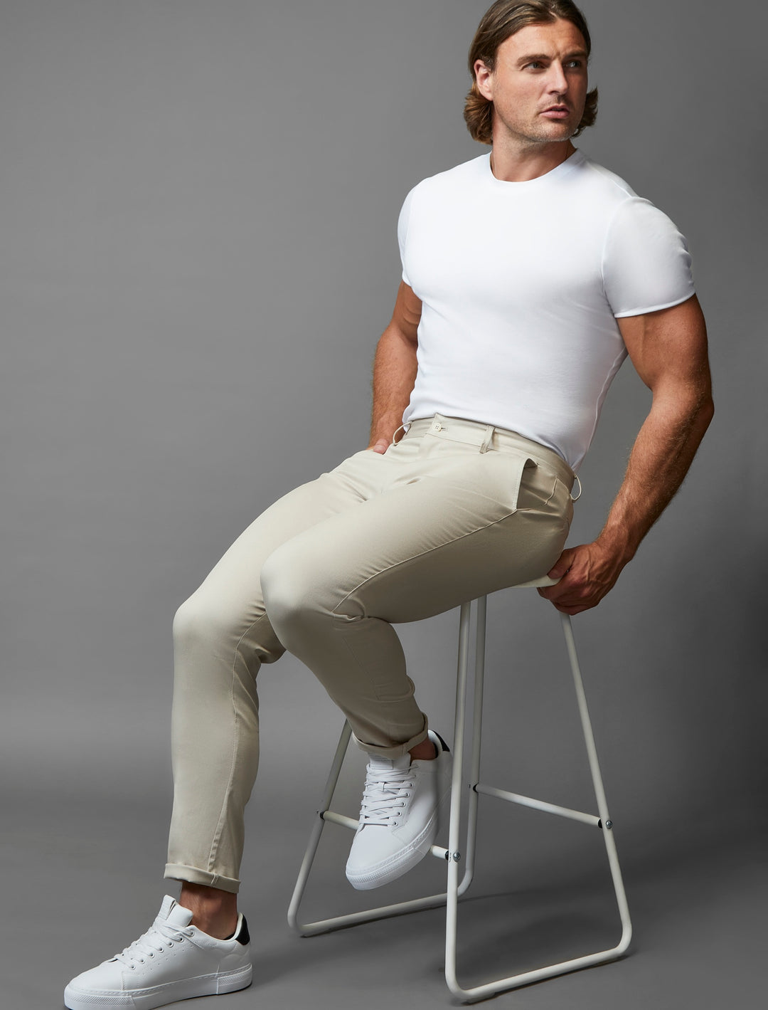 Stretch-enhanced beige chinos in an athletic fit, a signature design by Tapered Menswear.