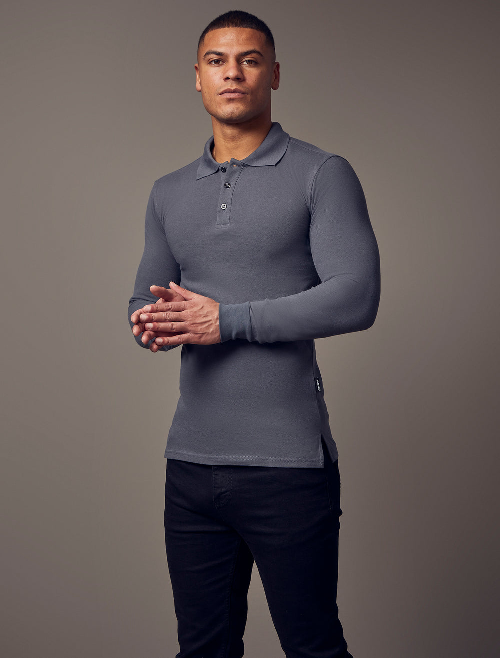  Long-sleeve, dark grey, tapered-fit polo shirt designed for a muscle-fit appearance, offering a sleek and comfortable silhouette.