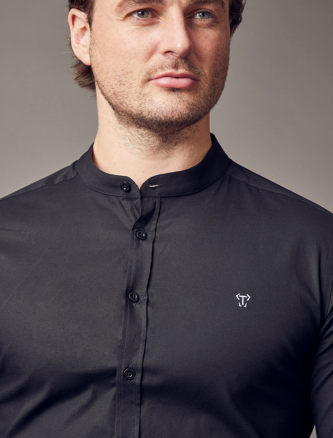  grandad collar black tapered fit shirt close up shot, emphasizing the muscle fit features for a flattering and well-sculpted look by Tapered
