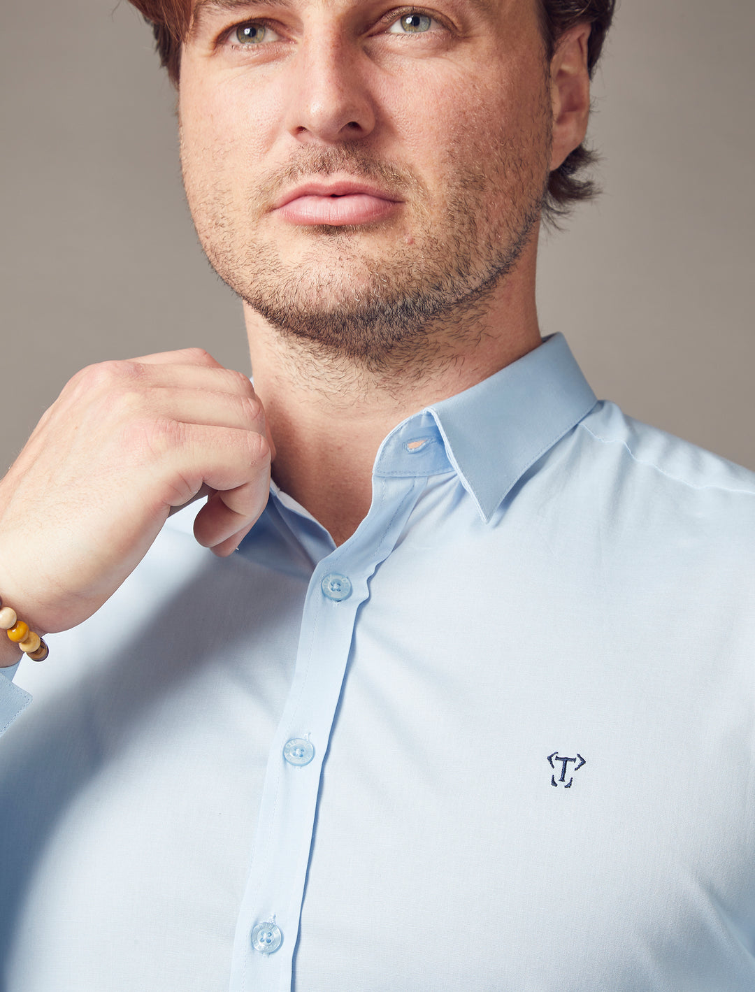 Light blue tapered fit shirt by Tapered Menswear, emphasizing the muscle-fit characteristics to offer a flattering and sharply defined silhouette.