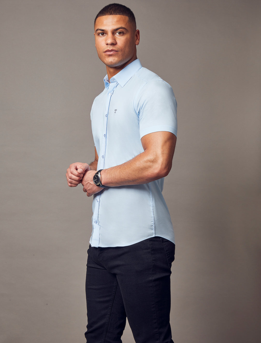 A blue short-sleeve shirt from Tapered Menswear, featuring a tapered fit that highlights the muscle-fit design, offering a comfortable and well-tailored look.