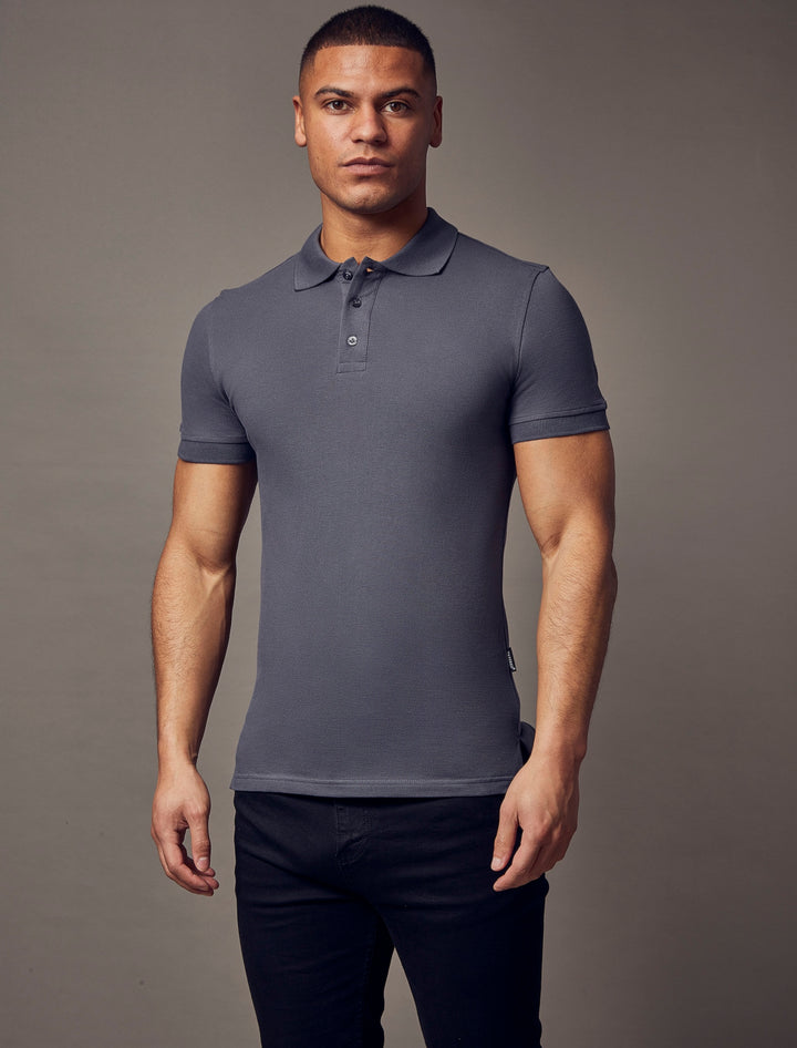 A sleek, dark grey polo shirt with a muscle-fit and short sleeves, crafted by Tapered Menswear to emphasize its high-quality, tapered design.