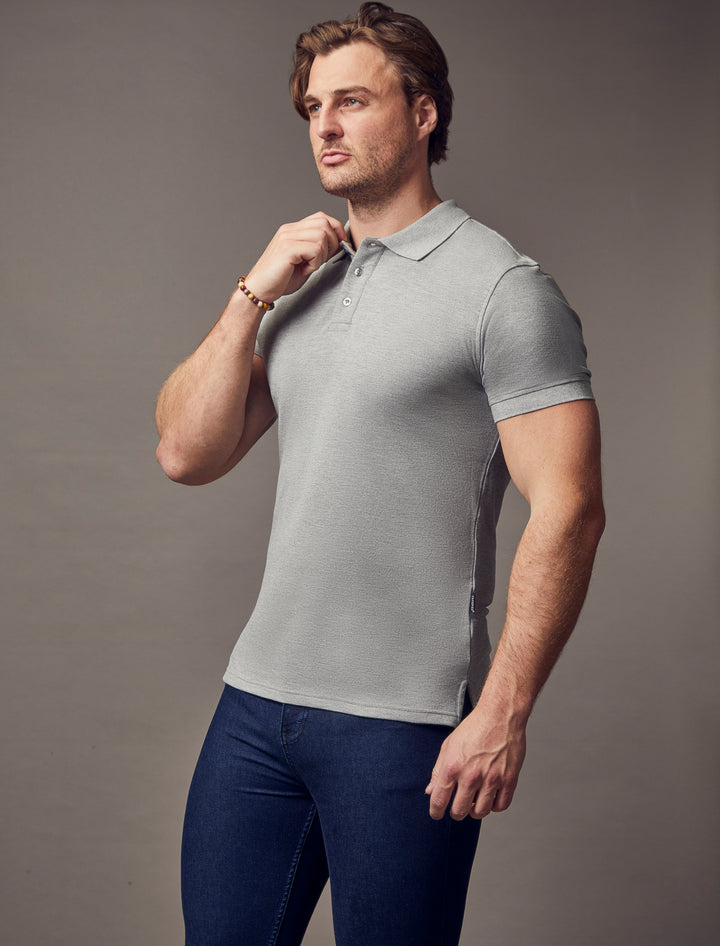 A grey, muscle-fit polo shirt with short sleeves by Tapered Menswear, emphasizing its premium quality and tapered silhouette.