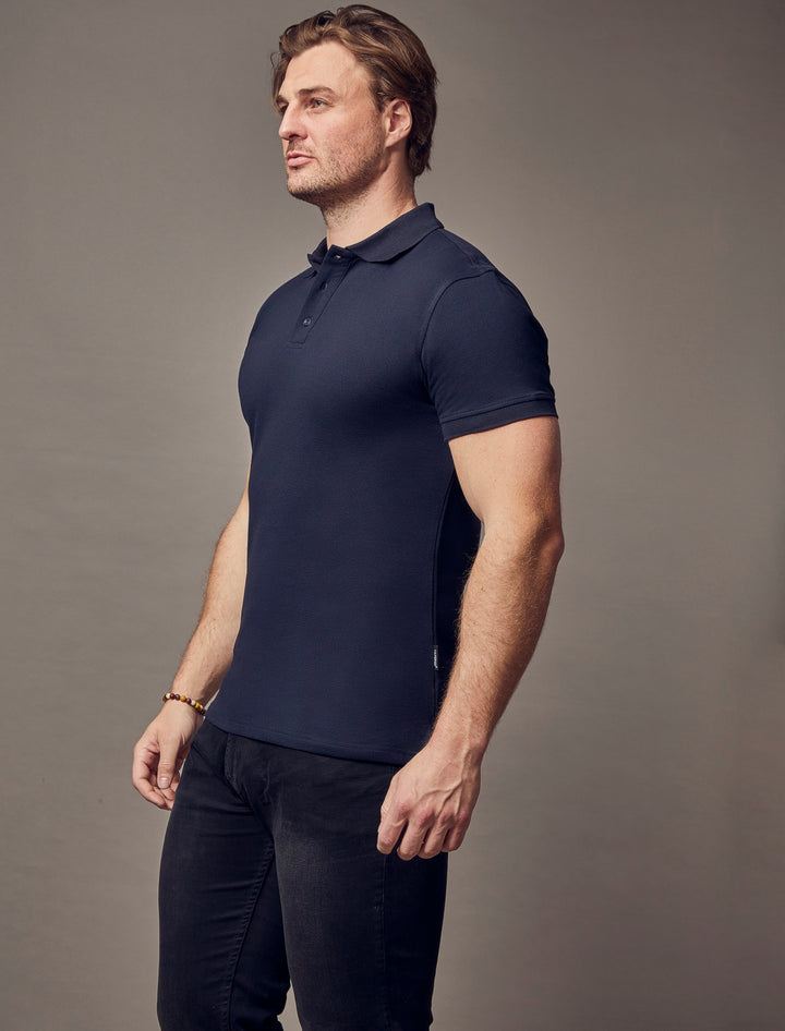 A navy polo shirt with short sleeves from Tapered Menswear, crafted in a tapered fit to highlight its muscle-fit attributes for a flattering and defined look.