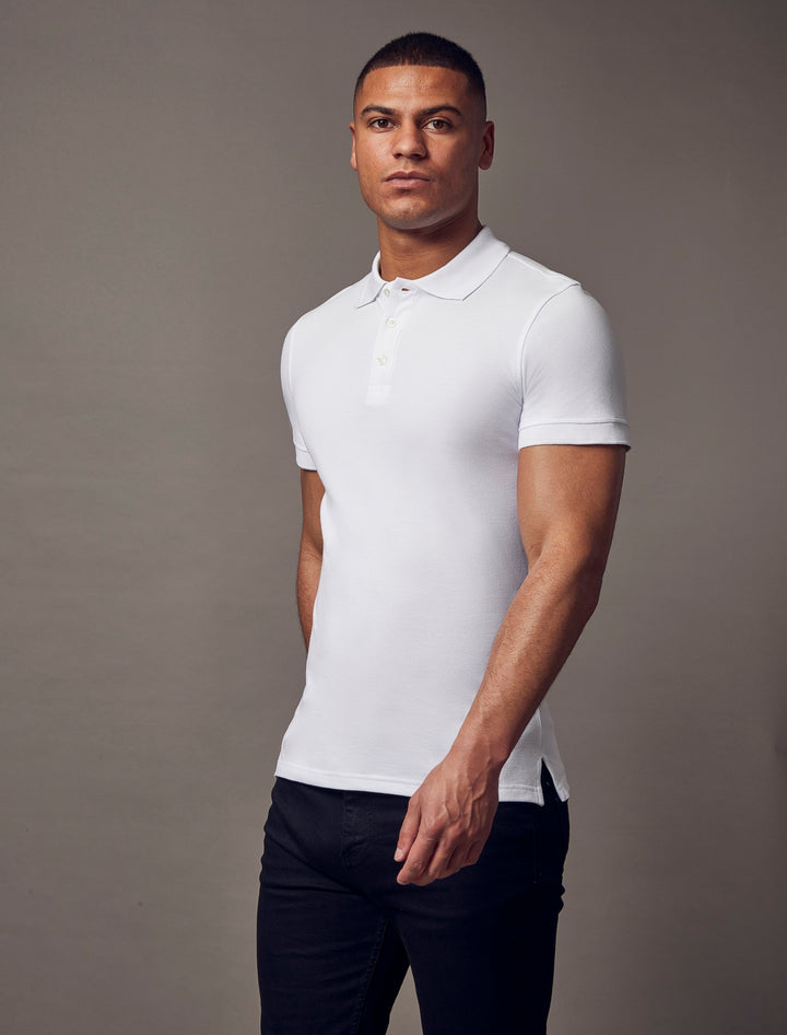 A white polo shirt with short sleeves from Tapered Menswear, designed with a tapered fit and muscle fit design for a stylish and comfortable silhouette.