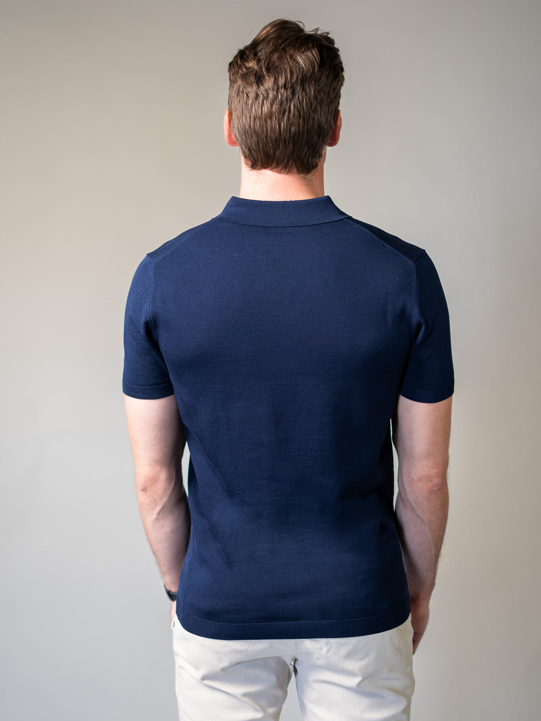 Tapered fit navy knit polo with revere collar ideal for smart-casual dressing