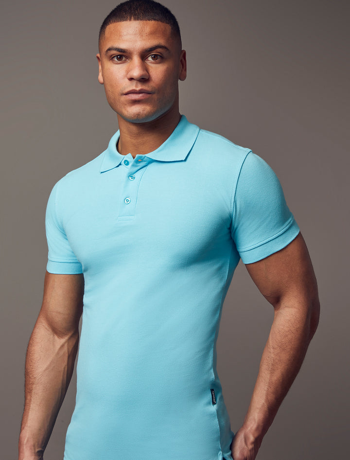 A turquoise, short-sleeve polo shirt with a muscle fit from Tapered Menswear, showcasing its tapered design and superior quality.