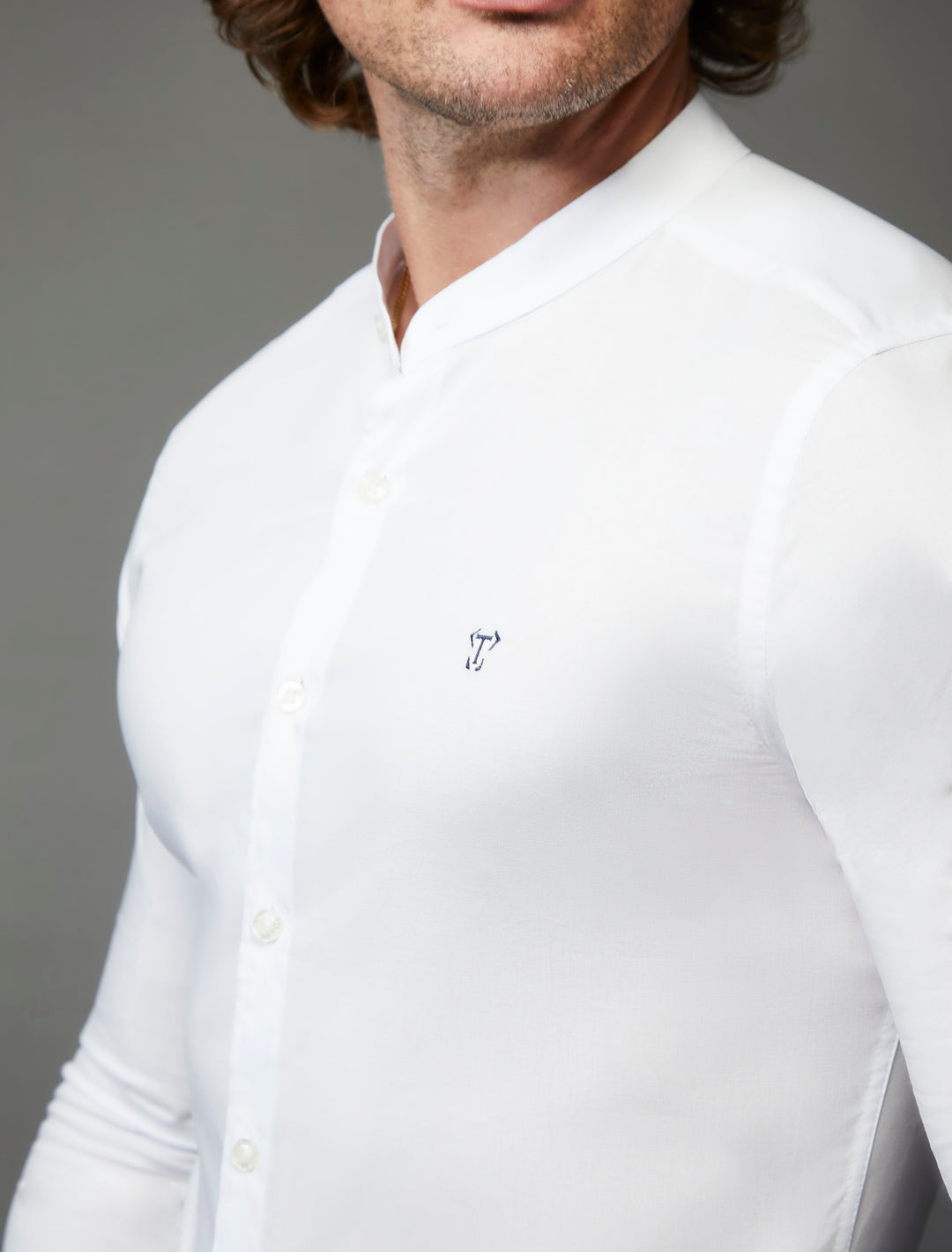 Close-up of a white grandad collar shirt in tapered muscle fit
