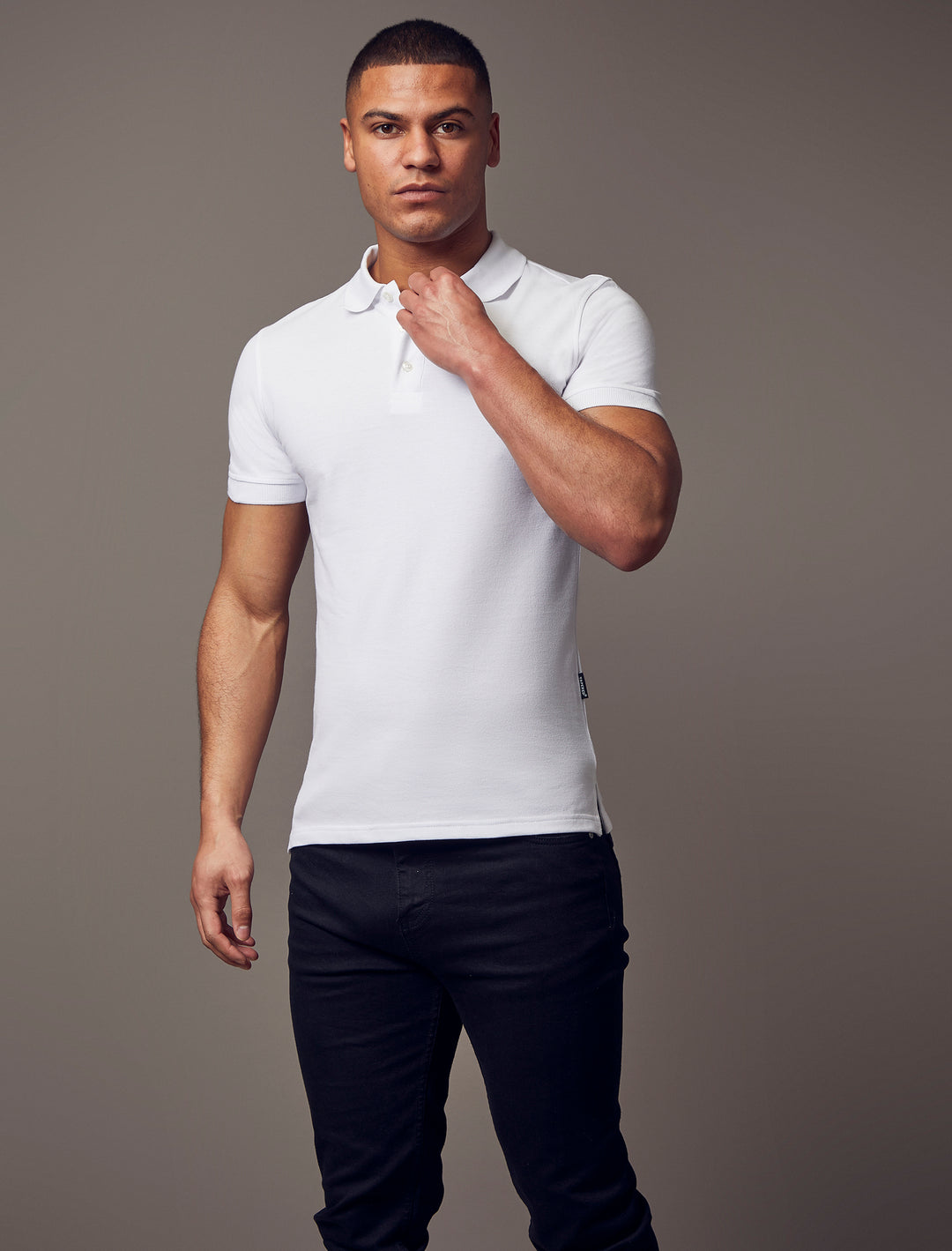  A short-sleeve, white polo shirt with a tapered fit by Tapered Menswear, highlighting the muscle fit design for a comfortable yet stylish silhouette.