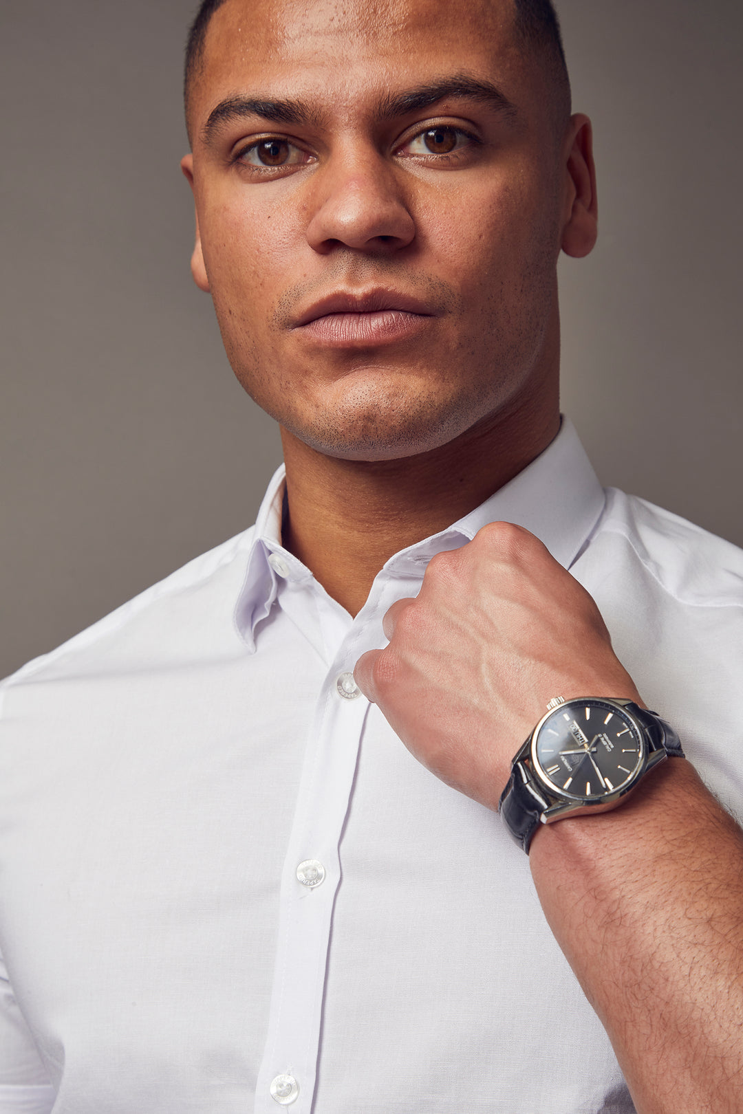 A white, short-sleeve shirt with a tapered fit from Tapered Menswear, highlighting its muscle-fit design for a comfortable yet fashionable silhouette.