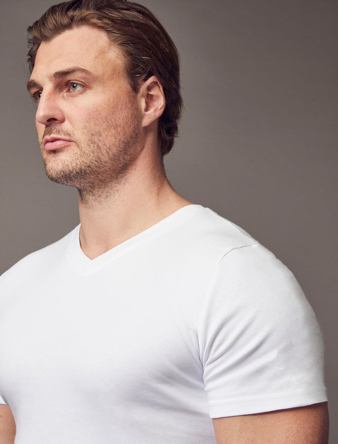 A white V-neck T-shirt from Tapered Menswear, crafted with a tapered fit and highlighting the muscle-fit design for a stylish and comfortable silhouette.